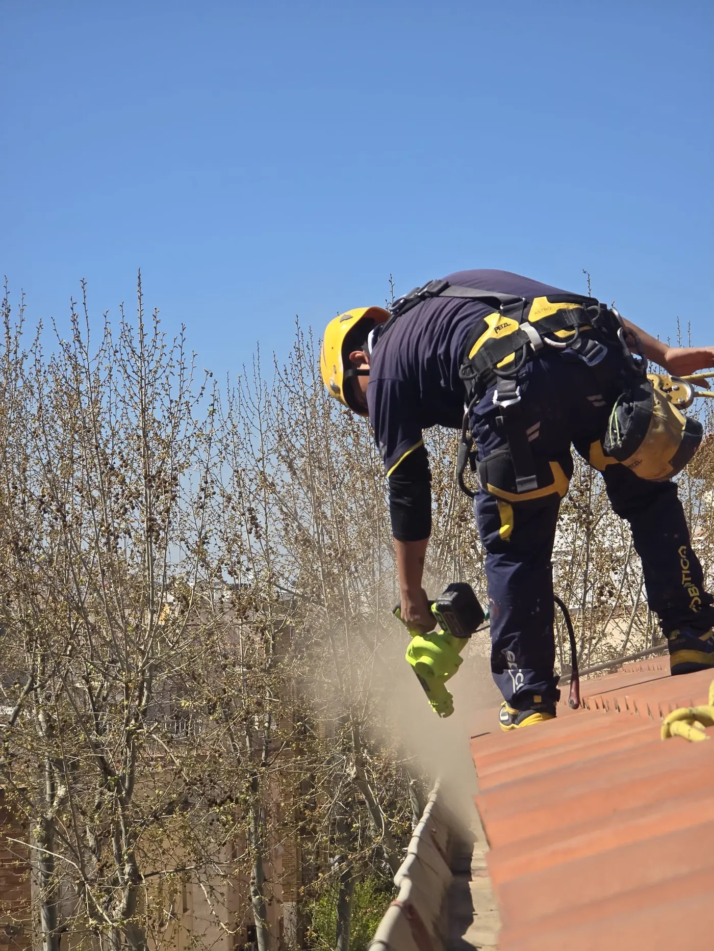 Operario reparando una cubierta inclinada de un edificio